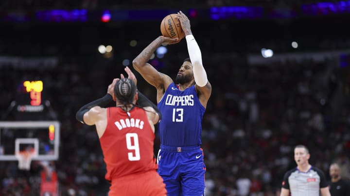 Mar 6, 2024; Houston, Texas, USA; Los Angeles Clippers forward Paul George (13) shoots the ball as Houston Rockets forward Dillon Brooks (9) defends during the fourth quarter at Toyota Center. Mandatory Credit: Troy Taormina-USA TODAY Sports