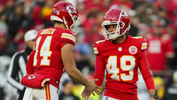 Nov 29, 2024; Kansas City, Missouri, USA; Kansas City Chiefs place kicker Matthew Wright (49) celebrates with punter Matt Araiza (14) after kicking a field goal during the second half against the Las Vegas Raiders at GEHA Field at Arrowhead Stadium. Mandatory Credit: Jay Biggerstaff-Imagn Images