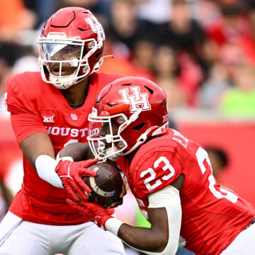 Nov 18, 2023; Houston, Texas, USA; Houston Cougars quarterback Donovan Smith (1) hands off the ball to running back Parker Jenkins (23) during the first quarter against the Oklahoma State Cowboys at TDECU Stadium. Mandatory Credit: Maria Lysaker-USA TODAY Sports