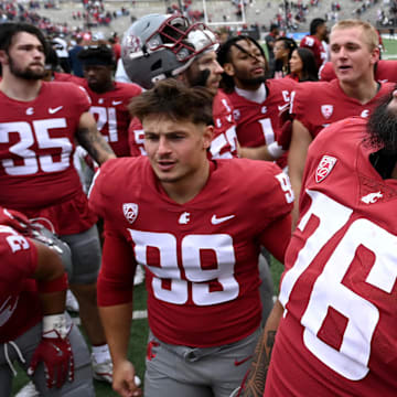 Washington State Cougars offensive lineman Esa Pole (76) celebrates after a victory over Hawaii.