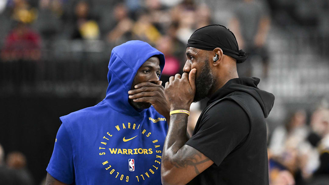 Oct 15, 2024; Las Vegas, Nevada, USA; Golden State Warriors forward Draymond Green (23) and Los Angeles Lakers forward LeBron James (23) talk on court before warm up at T-Mobile Arena. Mandatory Credit: Candice Ward-Imagn Images