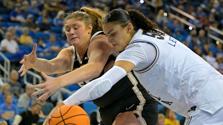 Jan 21, 2026; Los Angeles, California, USA;  Purdue Boilermakers forward Avery Gordon (55) and UCLA Bruins center Lauren Betts (51) reach for a loose ball in the second half at Pauley Pavilion presented by Wescom Financial. Mandatory Credit: Jayne Kamin-Oncea-Imagn Images