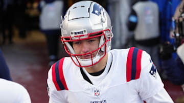 New England Patriots quarterback Drake Maye (10) runs onto the field before the game against the Buffalo Bills at Highmark Stadium.