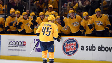 Jan 13, 2024; Nashville, Tennessee, USA; Nashville Predators defenseman Alexandre Carrier (45) celebrates with teammates after scoring the game-winning goal during the third period against the New York Islanders at Bridgestone Arena. Mandatory Credit: Christopher Hanewinckel-USA TODAY Sports