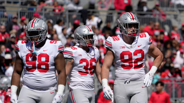 Ohio State Buckeyes defensive tackle Kayden McDonald (98), linebacker Gabe Powers (36) and defensive end Caden Curry (92)