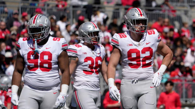 Ohio State Buckeyes defensive tackle Kayden McDonald (98), linebacker Gabe Powers (36) and defensive end Caden Curry