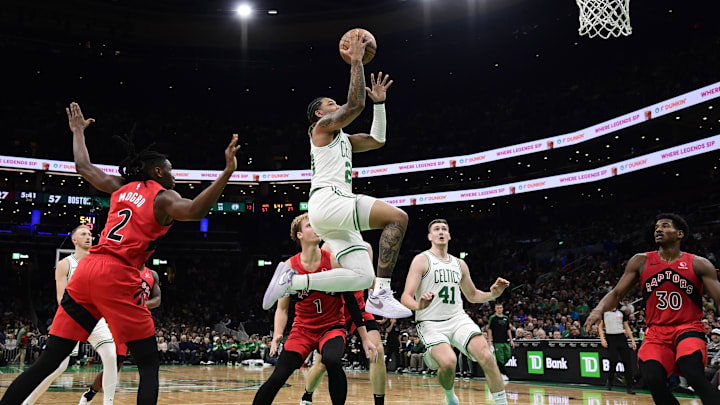 Oct 13, 2024; Boston, Massachusetts, USA; Boston Celtics guard JD Davison (20) drives to the basket past Toronto Raptors forward Jonathan Mogbo (2) during the first half at TD Garden. Mandatory Credit: Bob DeChiara-Imagn Images Oct 13, 2024; Boston, Massachusetts, USA; Boston Celtics guard JD Davison (20) drives to the basket past Toronto Raptors forward Jonathan Mogbo (2) during the first half at TD Garden. Mandatory Credit: Bob DeChiara-Imagn Images