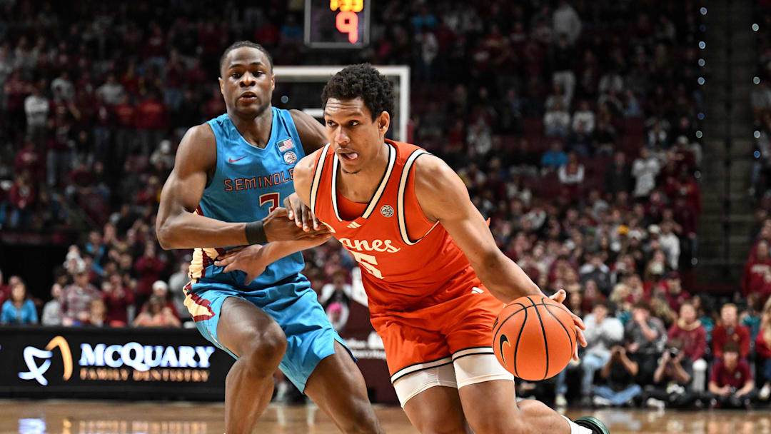 Feb 24, 2026; Tallahassee, Florida, USA; Miami Hurricanes forward Treyvon Maddox (5) drives the ball up the court past Florida State Seminoles forward Thomas Bassong (3) during the second half at Donald L. Tucker Center. Mandatory Credit: Melina Myers-Imagn Images