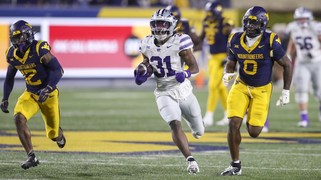 Oct 19, 2024; Morgantown, West Virginia, USA; Kansas State Wildcats running back DJ Giddens (31) runs after a catch during the third quarter against the West Virginia Mountaineers at Mountaineer Field at Milan Puskar Stadium. Mandatory Credit: Ben Queen-Imagn Images