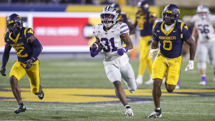 Oct 19, 2024; Morgantown, West Virginia, USA; Kansas State Wildcats running back DJ Giddens (31) runs after a catch during the third quarter against the West Virginia Mountaineers at Mountaineer Field at Milan Puskar Stadium. Mandatory Credit: Ben Queen-Imagn Images