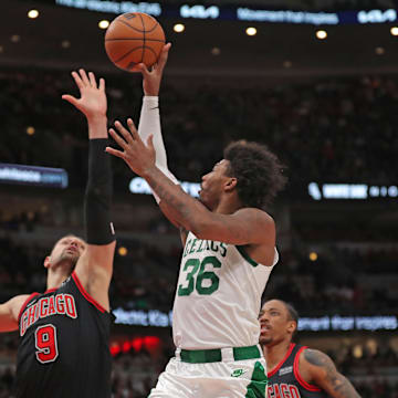 Apr 6, 2022; Chicago, Illinois, USA;Boston Celtics guard Marcus Smart (36) shoots over Chicago Bulls center Nikola Vucevic (9)  during the first half at the United Center. Mandatory Credit: Dennis Wierzbicki-Imagn Images