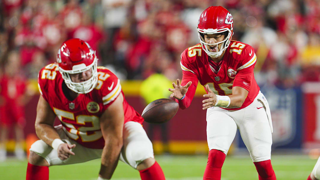 Sep 5, 2024; Kansas City, Missouri, USA; Kansas City Chiefs starting quarterback Patrick Mahomes (15) takes the snap from center Creed Humphrey (52) during the second half against the Baltimore Ravens at GEHA Field at Arrowhead Stadium. Mandatory Credit: Jay Biggerstaff-Imagn Images