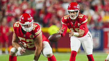 Sep 5, 2024; Kansas City, Missouri, USA; Kansas City Chiefs starting quarterback Patrick Mahomes (15) takes the snap from center Creed Humphrey (52) during the second half against the Baltimore Ravens at GEHA Field at Arrowhead Stadium. Mandatory Credit: Jay Biggerstaff-Imagn Images