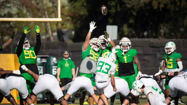 Oregon players attempt to block a kick by kicker Grant Meadors during practice with the Oregon Ducks.