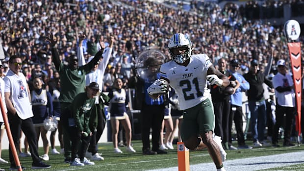 Tulane Green Wave running back Makhi Hughes (21) scores a touchdown during the first half against the Navy Midshipmen