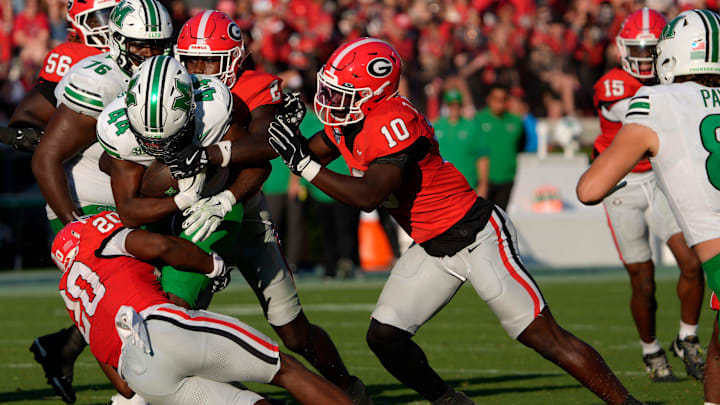 Marshall running back Antwan Roberts (44) is stopped by Georgia linebacker Zayden Walker (10) and Georgia safety Zion Branch (2) during the second half of a NCAA college football game against Marshall in Athens, Ga., on Saturday, August. 30, 2025. Georgia won 45-7.