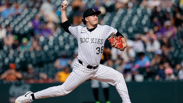 Vodnik in a black and white pinstripe uniform throwing off a dirt mound in black and white cleat
