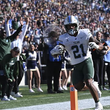 Nov 16, 2024; Annapolis, Maryland, USA;  Tulane Green Wave running back Makhi Hughes (21) scores a touchdown during the first half against the Navy Midshipmen at Navy-Marine Corps Memorial Stadium. Mandatory Credit: Tommy Gilligan-Imagn Images