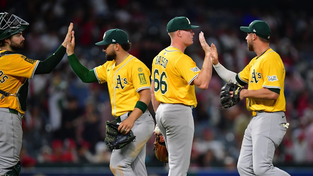 Sep 6, 2025; Anaheim, California, USA; Athletics and pitcher Brady Basso (66) celebrate the victory against the Los Angeles Angels at Angel Stadium. Mandatory Credit: Gary A. Vasquez-Imagn Images
