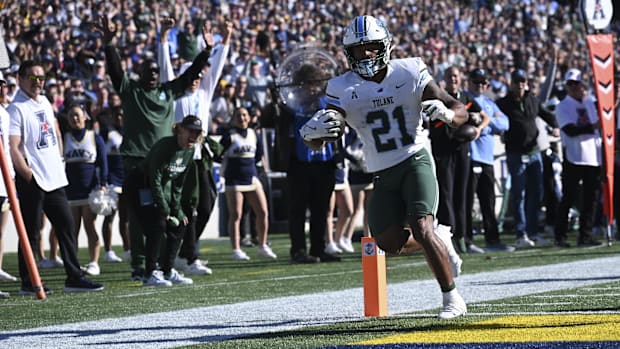 Nov 16, 2024; Annapolis, Maryland, USA;  Tulane Green Wave running back Makhi Hughes (21) scores a touchdown during the first