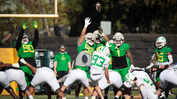 Oregon players attempt to block a kick by kicker Grant Meadors during practice with the Oregon Ducks Tuesday, April 2, 2024 in Eugene, Ore.