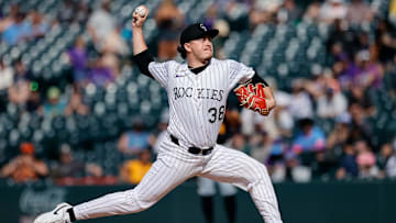 Aug 2, 2025; Denver, Colorado, USA; Colorado Rockies relief pitcher Victor Vodnik (38) pitches in the eighth inning against the Pittsburgh Pirates at Coors Field. 