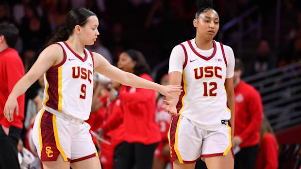 Feb 8, 2025; Los Angeles, California, USA; USC Trojans guard Kayleigh Heckel (9) and USC Trojans guard JuJu Watkins (12) duri