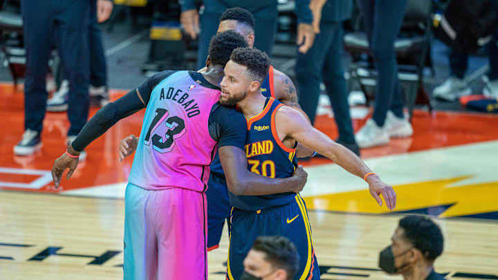 Miami Heat center Bam Adebayo (13) embraces Golden State Warriors guard Stephen Curry (30) after the game at Chase Center. 