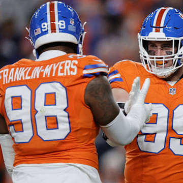 Nov 6, 2025; Denver, Colorado, USA; Denver Broncos defensive end Zach Allen (99) reacts with defensive end John Franklin-Myers (98) during the first half at Empower Field at Mile High. Mandatory Credit: Isaiah J. Downing-Imagn Images
