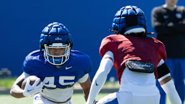 University of Kentucky wide receiver Darius Cannon makes his way around a defender during spring football practice on Saturday, April 6, 2024.