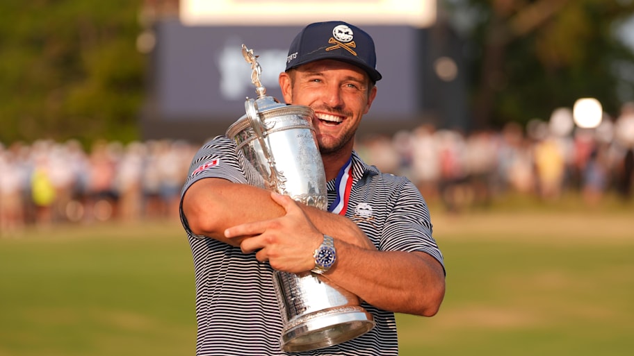 Bryson DeChambeau celebrates with the trophy after winning the U.S. Open golf tournament.