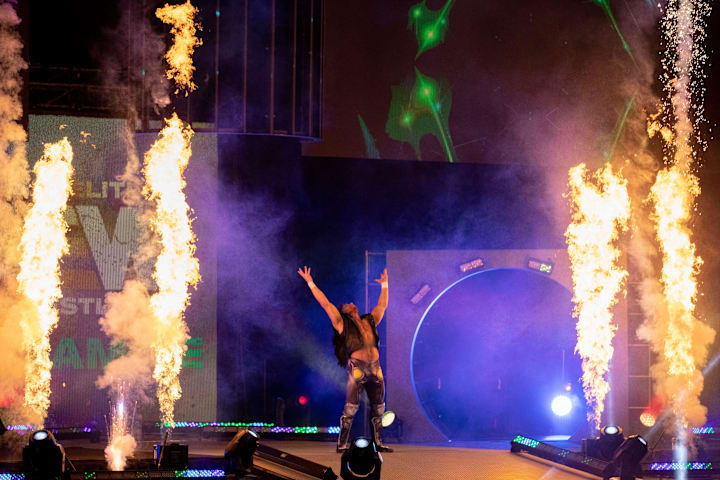 Scenes from the tag-team match between Kenny Omega, and Adam Page vs. Private Party.