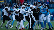 Tennessee running back Julius Chestnut (36), second right, and Jacksonville punter Logan Cooke (9) get into a skirmish after a Jacksonville punt in the fourth quarter of their game at Nissan Stadium Sunday, Nov. 30, 2025.