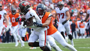 Sep 22, 2024; Tampa, Florida, USA; Denver Broncos linebacker Nik Bonitto (15) tackles Tampa Bay Buccaneers running back Bucky Irving (7) during the first half at Raymond James Stadium. Mandatory Credit: Kim Klement Neitzel-Imagn Images
