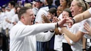Penn State men's basketball coach Mike Rhoades high-fives students following a Big Ten game vs. the Ohio State Buckeyes at Bryce Jordan Center.