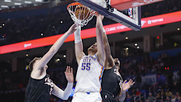 Nov 20, 2024; Oklahoma City, Oklahoma, USA; Oklahoma City Thunder center Isaiah Hartenstein (55) dunks between Portland Trail Blazers center Donovan Clingan (23) and forward Toumani Camara (33) during the second half at Paycom Center. Mandatory Credit: Alonzo Adams-Imagn Images