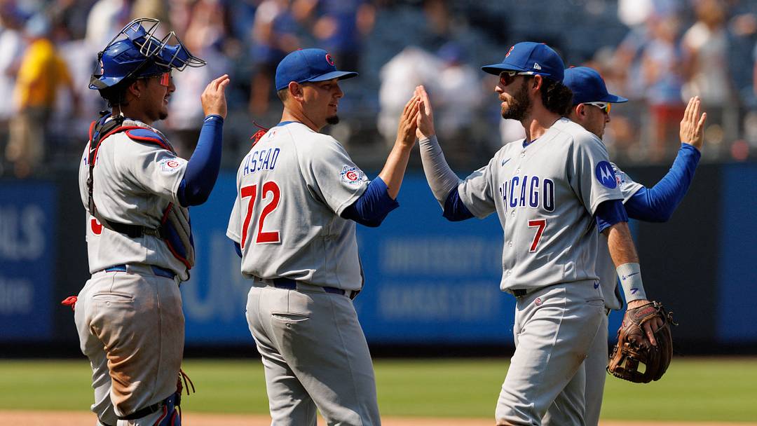 Aug 9, 2026; Kansas City, Missouri, USA; Chicago Cubs shortstop Dansby Swanson (7) slaps hands with Chicago Cubs pitcher Javier Assad (72) after the game against the Kansas City Royals at Kauffman Stadium. Mandatory Credit: William Purnell-Imagn Images