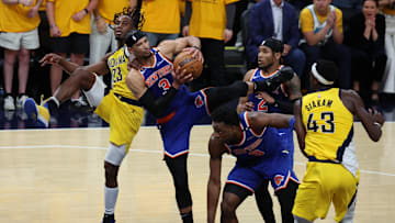 New York Knicks guard Josh Hart and Indiana Pacers forward Aaron Nesmith battle for control of the ball during the fourth quarter of game three.