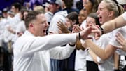 Penn State men's basketball coach Mike Rhoades high-fives Penn students following a game at Bryce Jordan Center.  