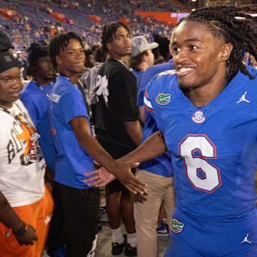 Florida Gators wide receiver Elijhah Badger (6) gives high-fives to fans after the Gators defeated the LSU Tiger 27-26 at Ben Hill Griffin Stadium in Gainesville, FL on Saturday, November 16, 2024. [Doug Engle/Gainesville Sun]