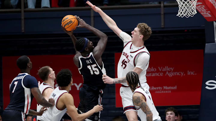 Feb 28, 2026; Moraga, California, USA; Gonzaga Bulldogs forward Graham Ike (15) goes up for a shot while being defended by St. Mary's Gaels center Andrew McKeever (45) during the second half at University Credit Union Pavilion. Mandatory Credit: Dennis Lee-Imagn Images
