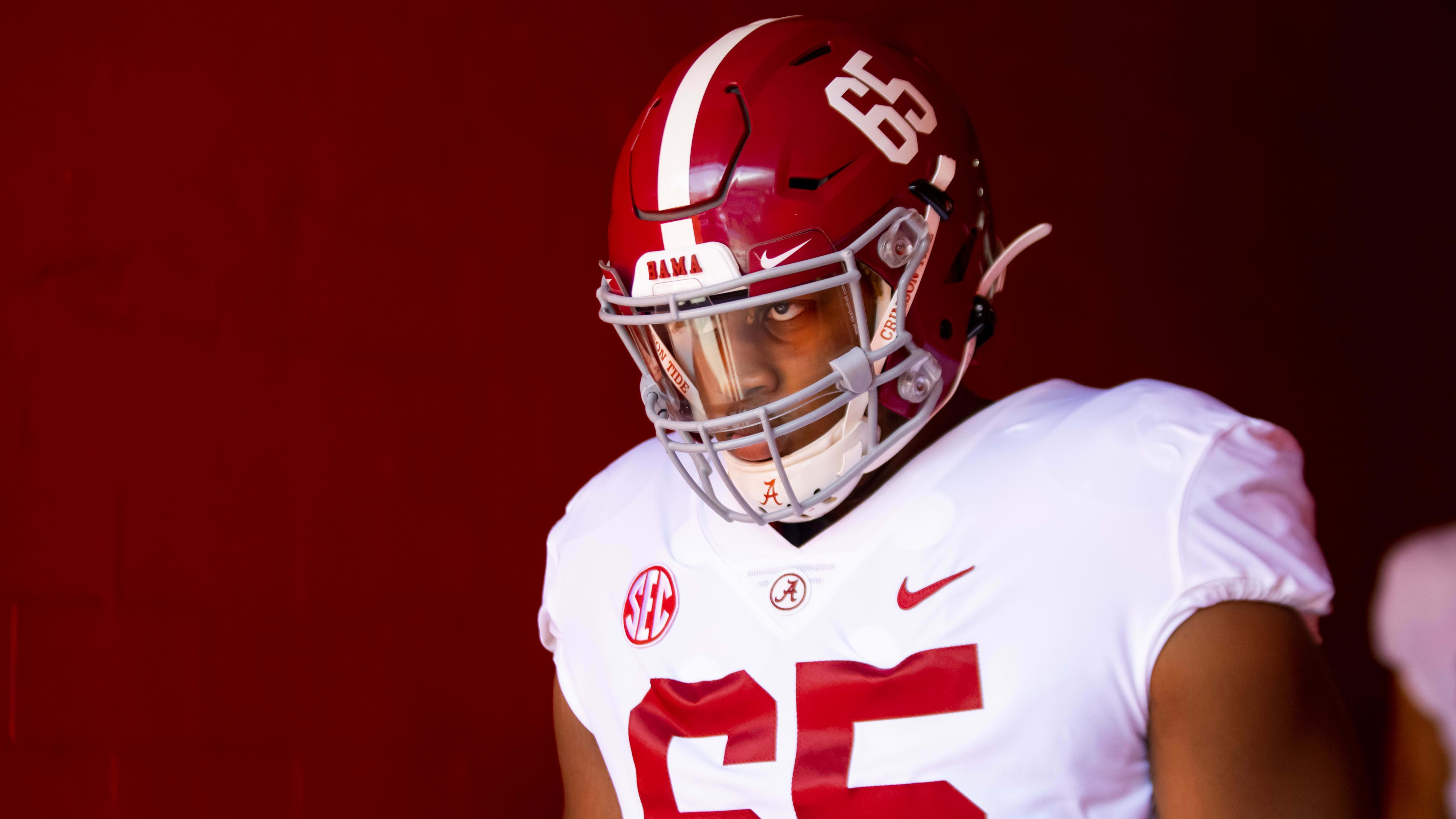 Alabama Crimson Tide defensive lineman JC Latham (65) awaits his entrance to the field in the tunnel.