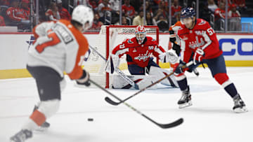 Sep 22, 2024; Washington, District of Columbia, USA; Washington Capitals goaltender Clay Stevenson (33) prepares to make a save on Philadelphia Flyers forward Jett Luchanko (17) Capitals forward Trevor van Riemsdyk (57) defends in the second period at Capital One Arena. Mandatory Credit: Geoff Burke-Imagn Images