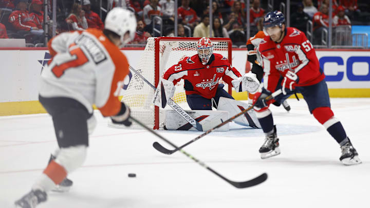 Sep 22, 2024; Washington, District of Columbia, USA; Washington Capitals goaltender Clay Stevenson (33) prepares to make a save on Philadelphia Flyers forward Jett Luchanko (17) Capitals forward Trevor van Riemsdyk (57) defends in the second period at Capital One Arena. Mandatory Credit: Geoff Burke-Imagn Images