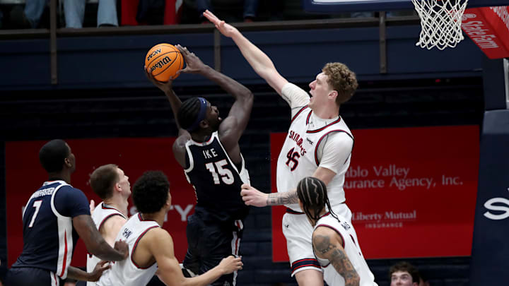 Feb 28, 2026; Moraga, California, USA; Gonzaga Bulldogs forward Graham Ike (15) goes up for a shot while being defended by St. Mary's Gaels center Andrew McKeever (45) during the second half at University Credit Union Pavilion. Mandatory Credit: Dennis Lee-Imagn Images