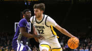 Iowa   s Owen Freeman (32) drives to the basket as Kansas State   s Cam Carter (5) defends in a