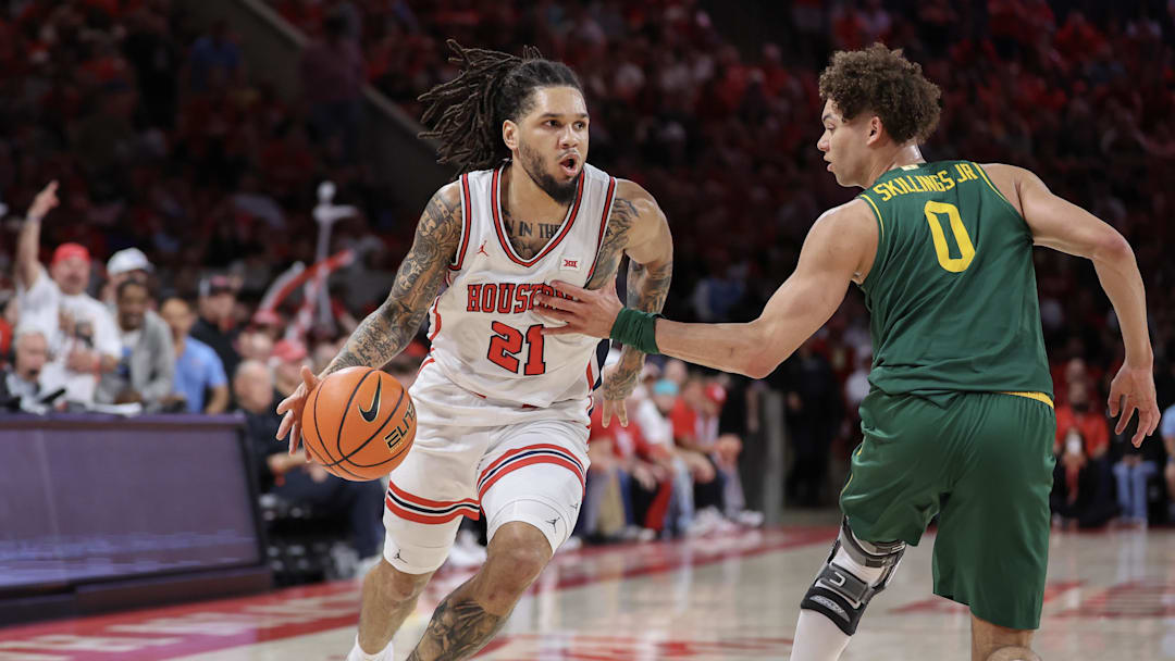 Mar 4, 2026; Houston, Texas, USA; Houston Cougars guard Emanuel Sharp (21) dribbles against Baylor Bears guard Dan Skillings Jr. (0) in the first half at Fertitta Center. Mandatory Credit: Thomas Shea-Imagn Images