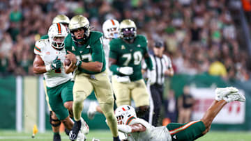 Sep 21, 2024; Tampa, Florida, USA; South Florida Bulls quarterback Byrum Brown (17) runs with the ball against the Miami Hurricanes in the third quarter  at Raymond James Stadium. Mandatory Credit: Nathan Ray Seebeck-Imagn Images