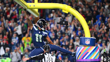 Oct 20, 2025; Seattle, Washington, USA; Seattle Seahawks wide receiver Jaxon Smith-Njigba (11) celebrates on the goal post after a touchdown during the first quarter against the Houston Texans at Lumen Field. Mandatory Credit: Steven Bisig-Imagn Images