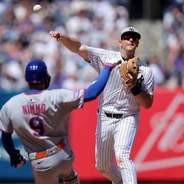 May 17, 2025; Bronx, New York, USA; New York Yankees second baseman DJ LeMahieu (26) forces out New York Mets left fielder Brandon Nimmo (9) at second base and throws to first to complete a double play on a ball hit by Mets designated hitter Mark Vientos (not pictured) during the sixth inning at Yankee Stadium. Mandatory Credit: Brad Penner-Imagn Images